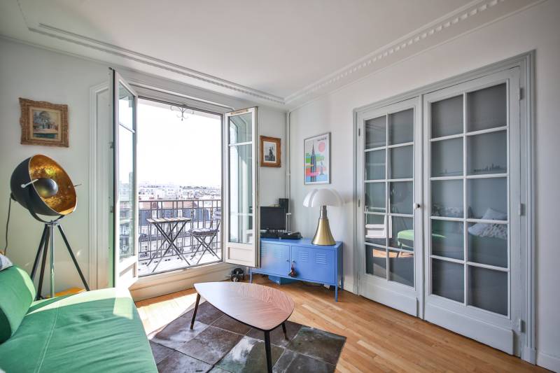 Séjour avec balcon d'un appartement aux charmes de l'ancien situé à Paris 15ème nord